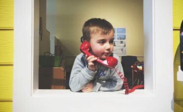 young-boy-talking-on-an-old-landline-telephone-pl-2025-01-08-07-55-17-utc